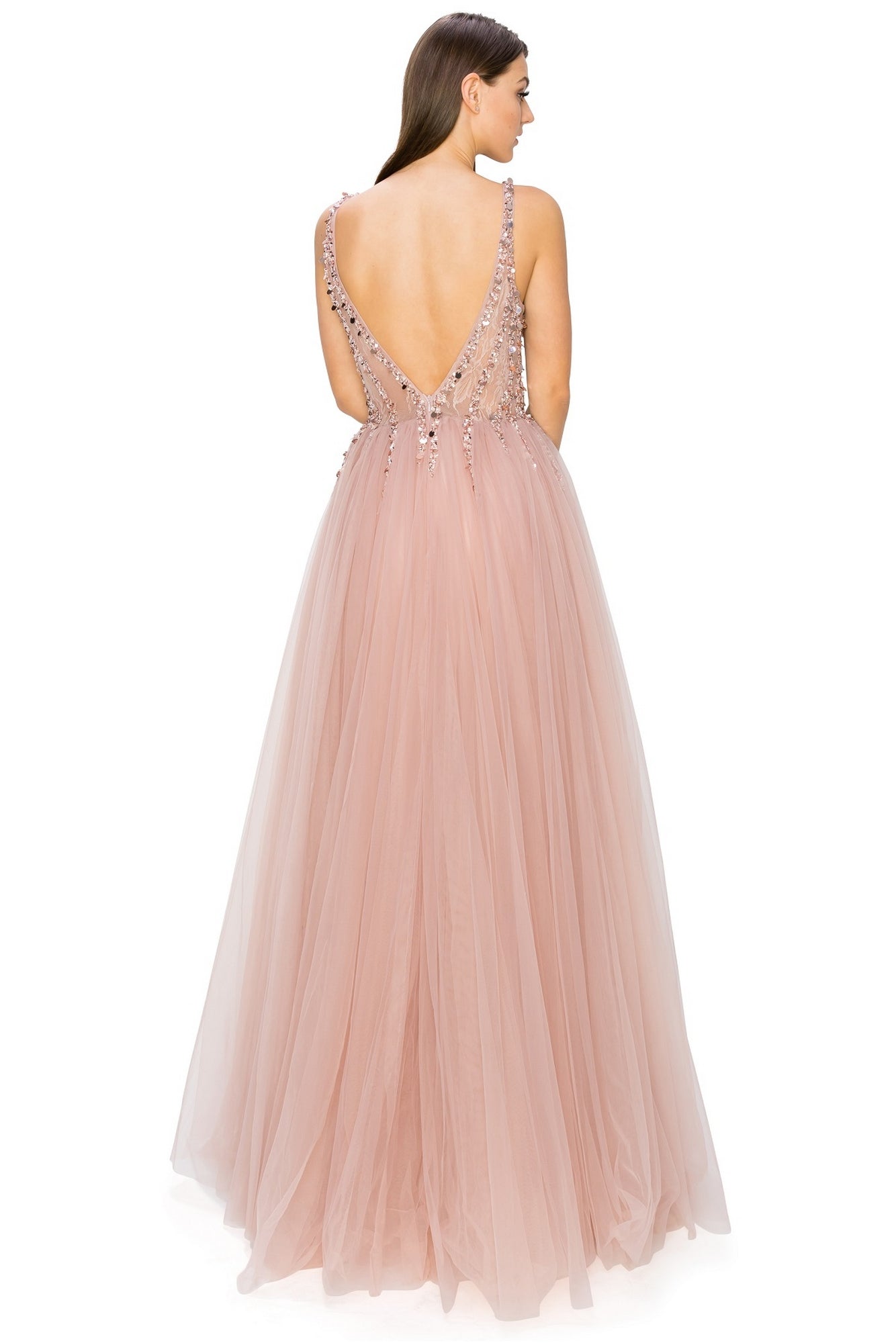 A woman stands with her back to the camera in the Long Tulle Prom Ball Gown with Sequins 8034J, a sleeveless, floor-length blush pink plus size dress featuring a deep V-back and elegant sequin embellishments.